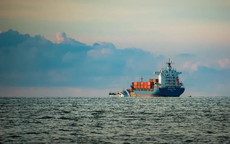 Container ship sailing at dusk